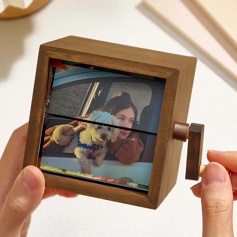 Custom wooden photo flipbook frame with hand crank displaying a personalized photo sequence